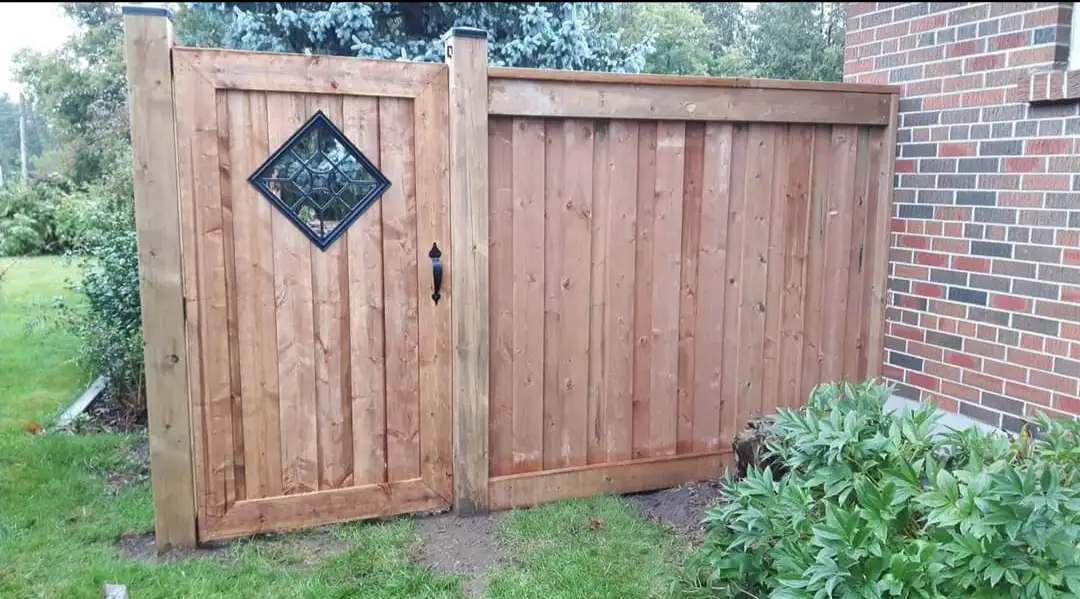 Custom wood fence and gate with decorative window insert
