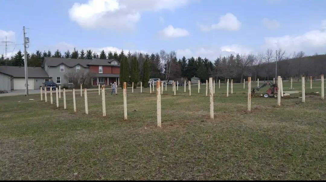 Large Done Well Post Holes job with many wood posts set across a property