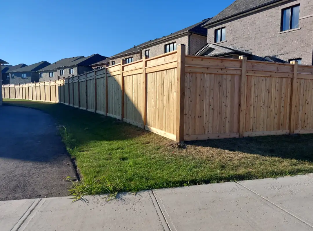 Long wood privacy fence installed beside homes